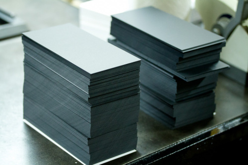 Stacks of cut Plike paper. Paper cutting isn't glamorous, but it's a very important step.